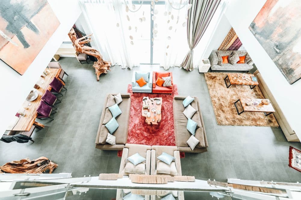 A furnished interior with sofas, rugs and open living areas
