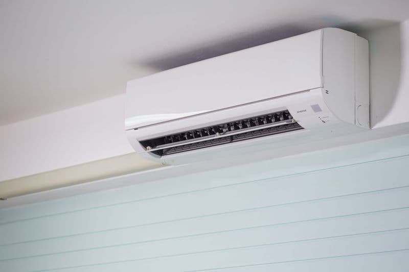 A wall-mounted air-conditioning unit in a room